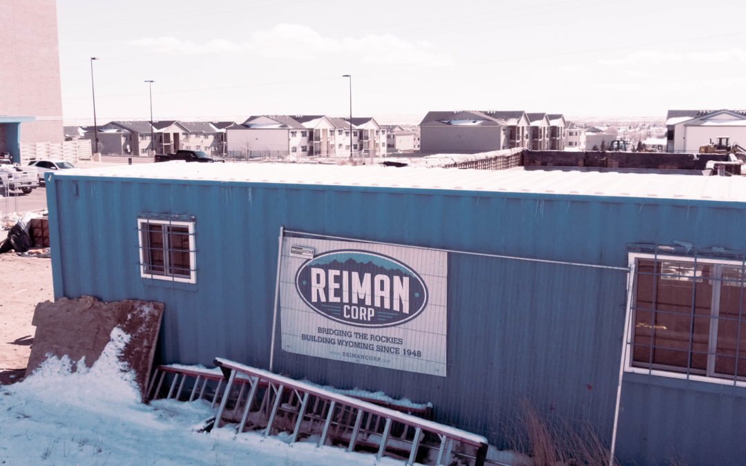 Reiman Corp container with houses in the background