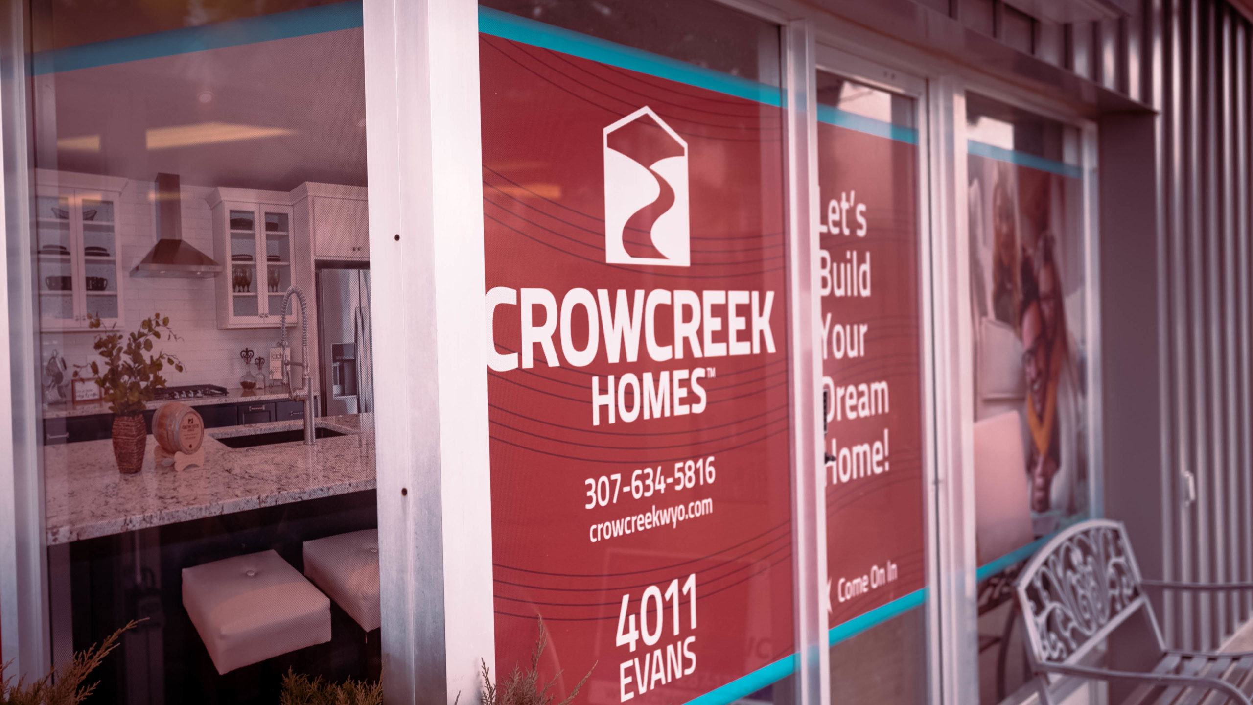 Crowcreek Homes Sign on glass windows and doors