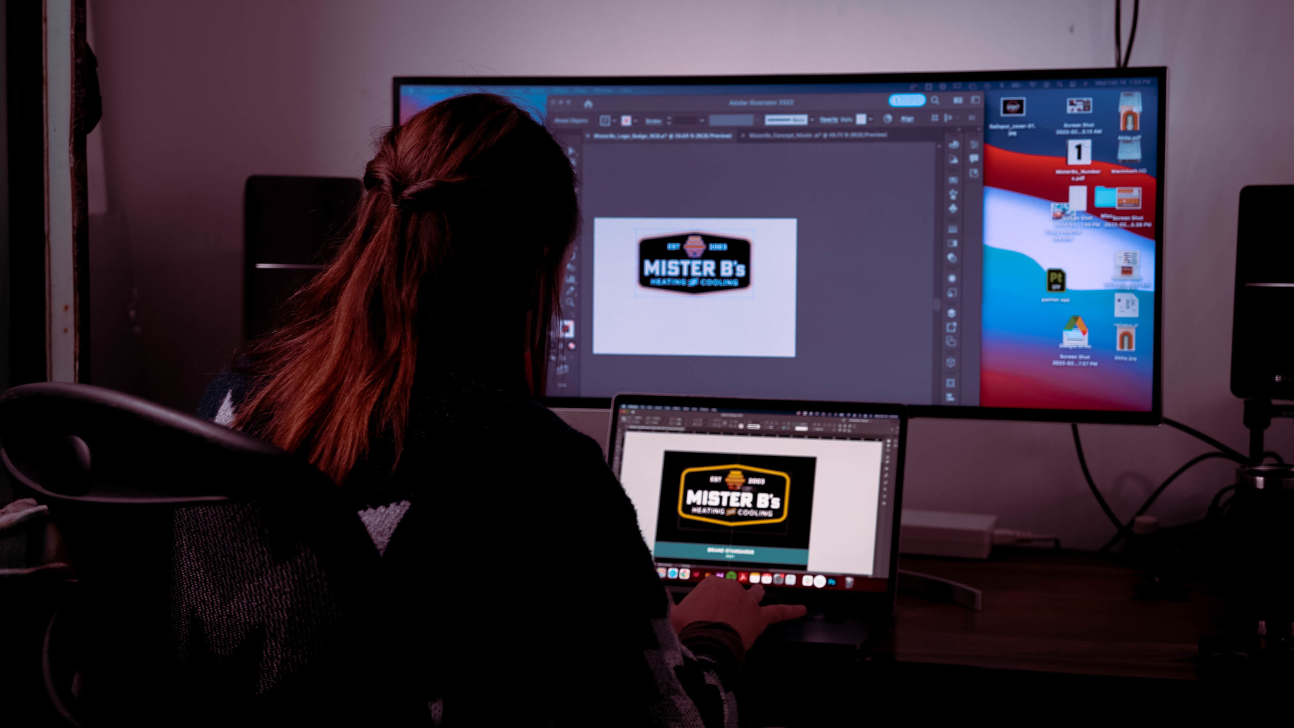 Woman on her computer designing a logo