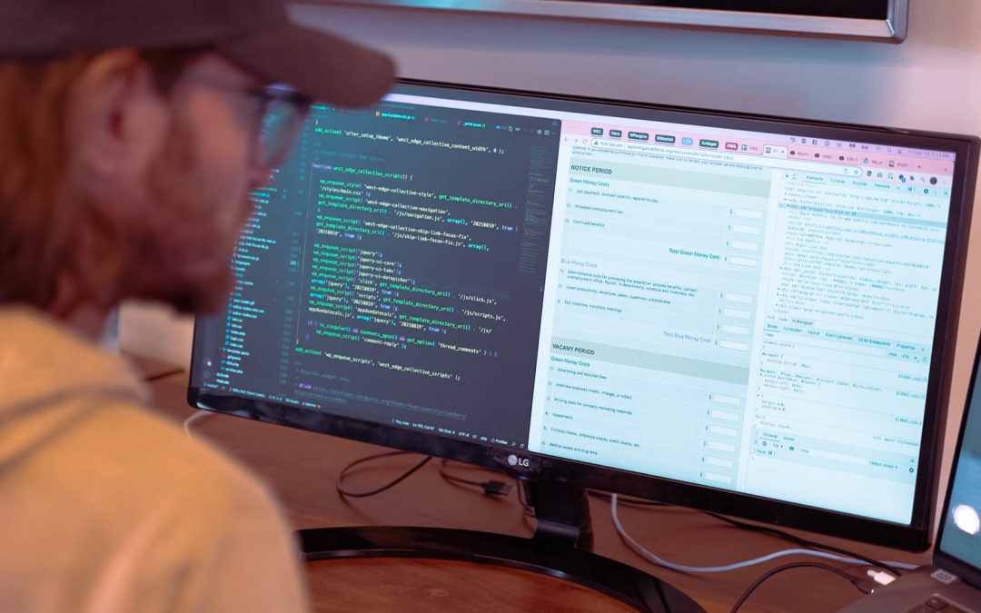 A man coding a website on his computer screen
