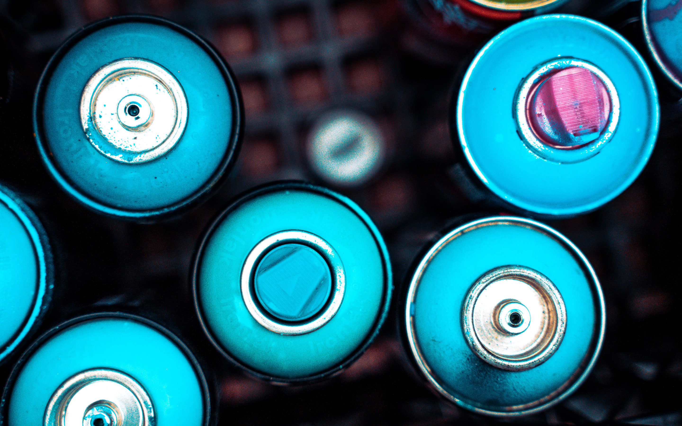 Top of teal spray paint cans