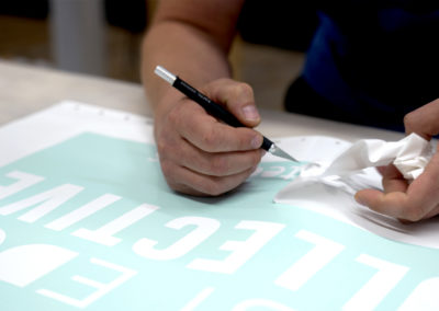 What are the benefits of a climate-controlled sign shop?