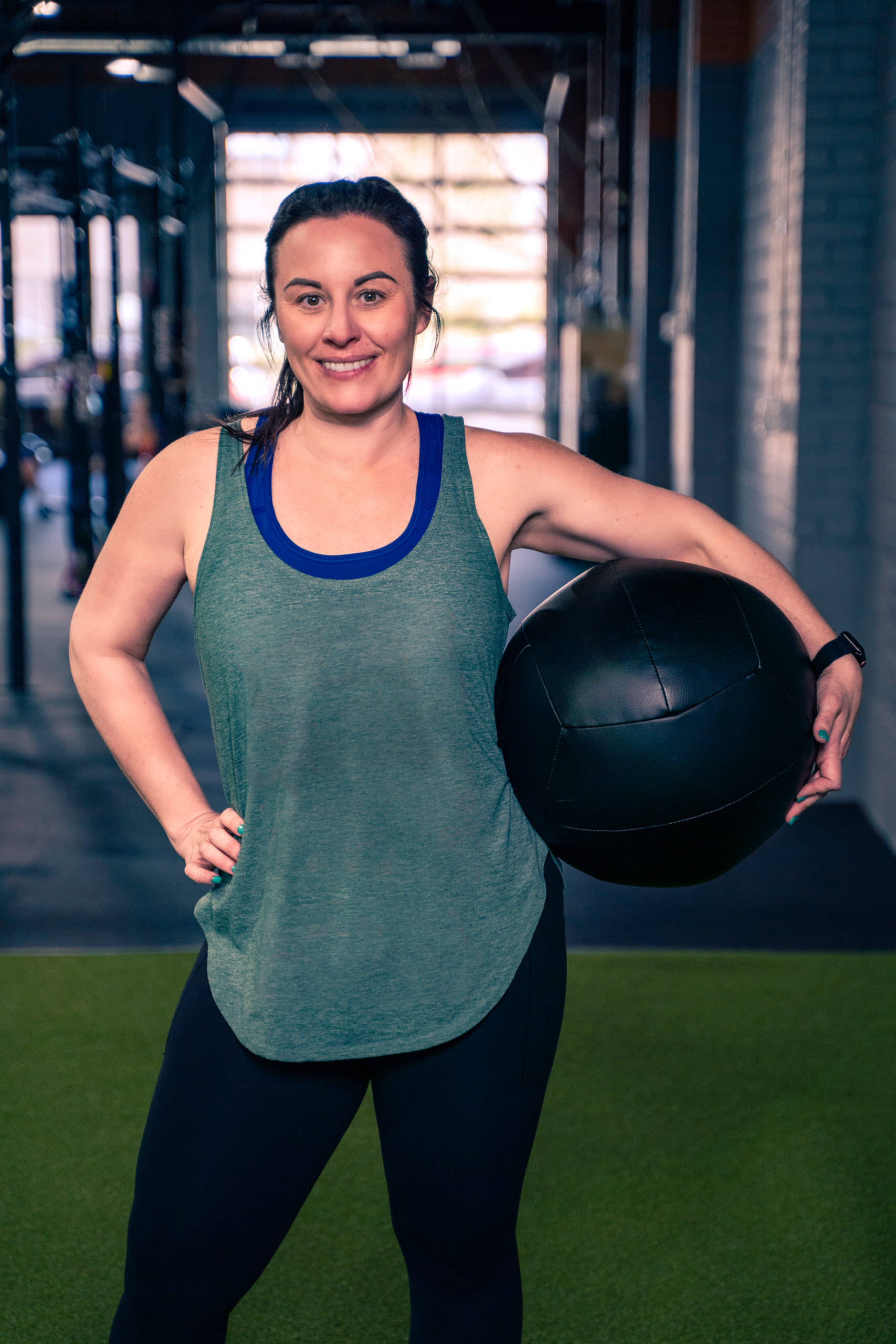 Woman at the gym holding weighted ball